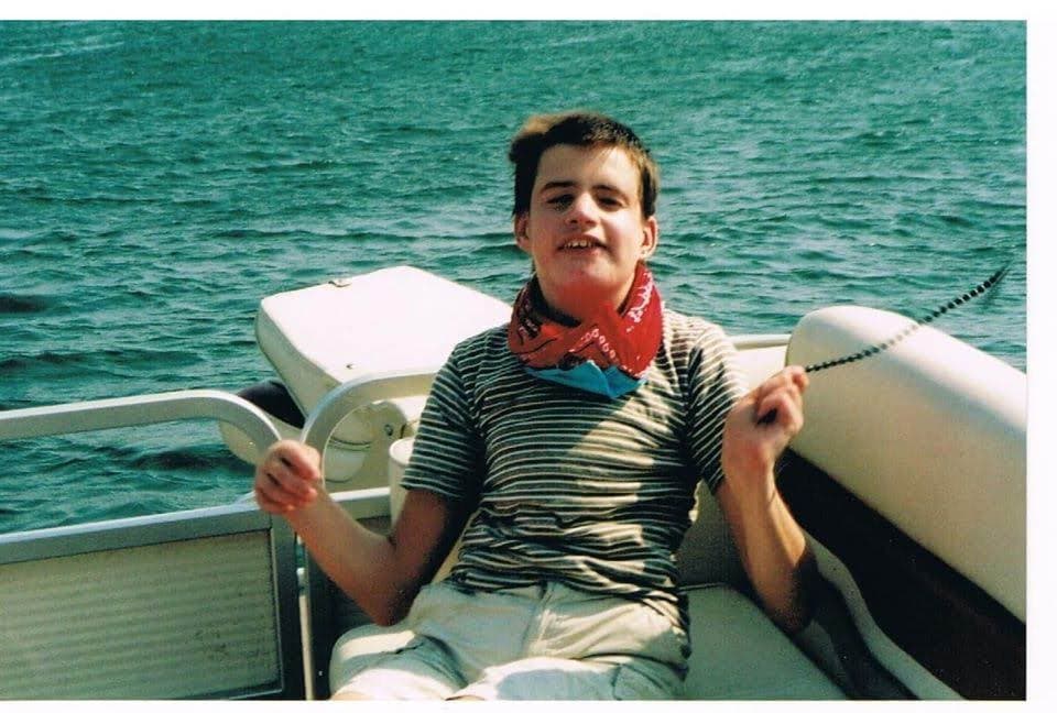 David smiling on the family boat